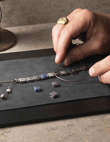 Artisan braiding a Shamballa bracelet by hand in Copenhagen